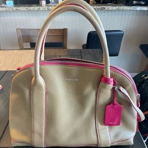 Large tan leather coach purse with pink trim